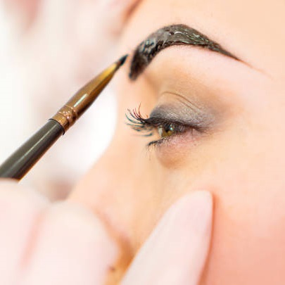 Eyebrow correction, eyebrows tinting treatment close-up.